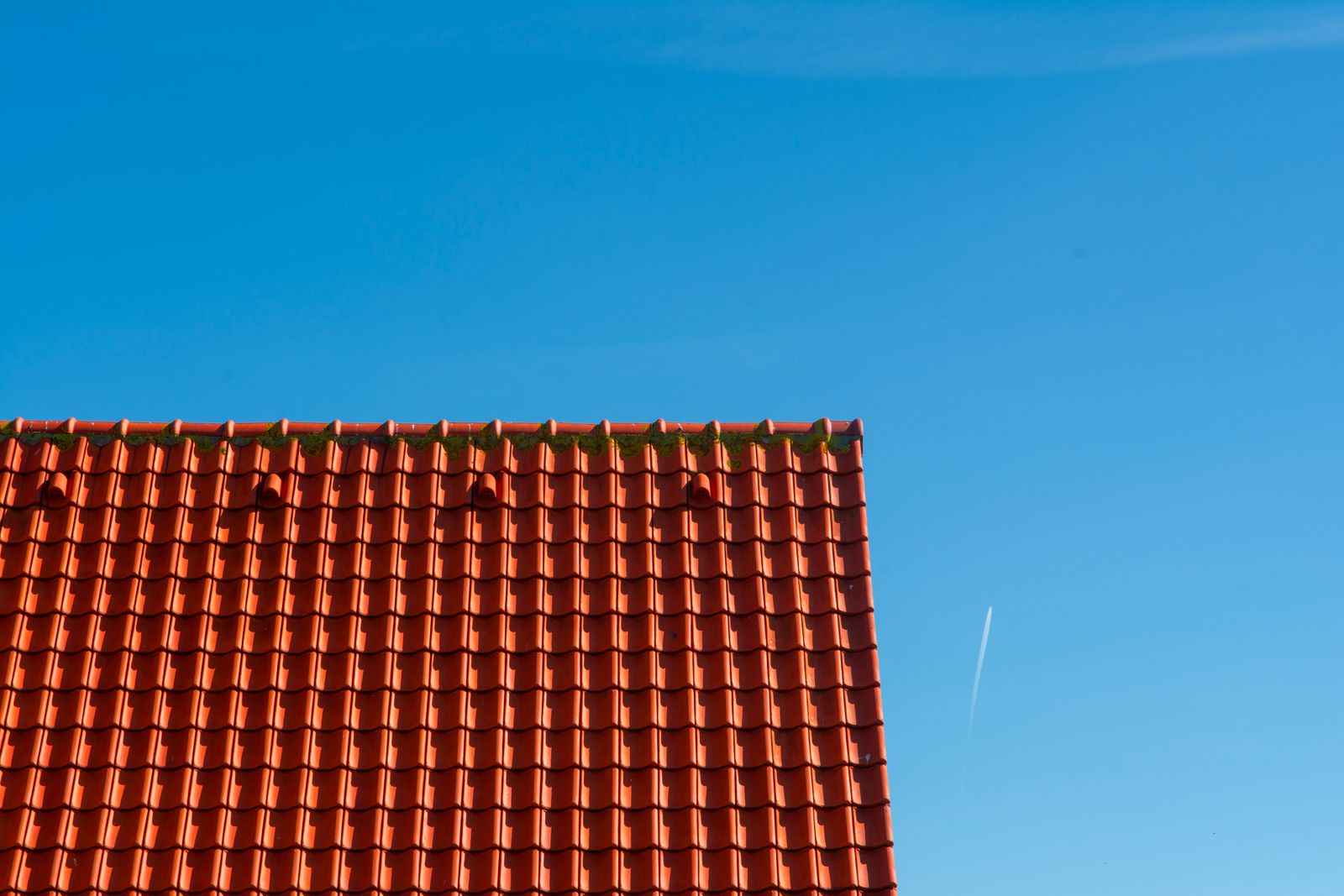 red-tile-roofline-blue-sky Red tile roofline against a clear blue sky