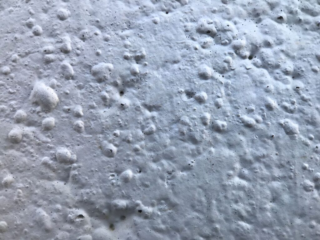 Close-up texture of a foam-coated roof surface
